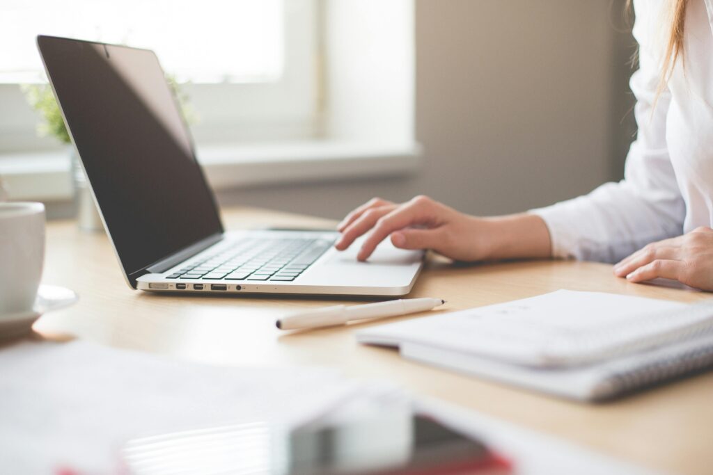 person sitting at desk using computer